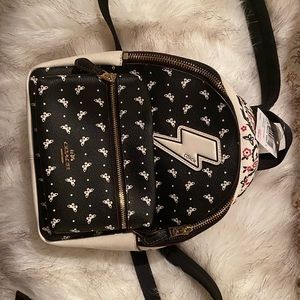 NWT CREAM COACH LEATHER BACK PACK detailed w/bright pink butterflies & flowers.